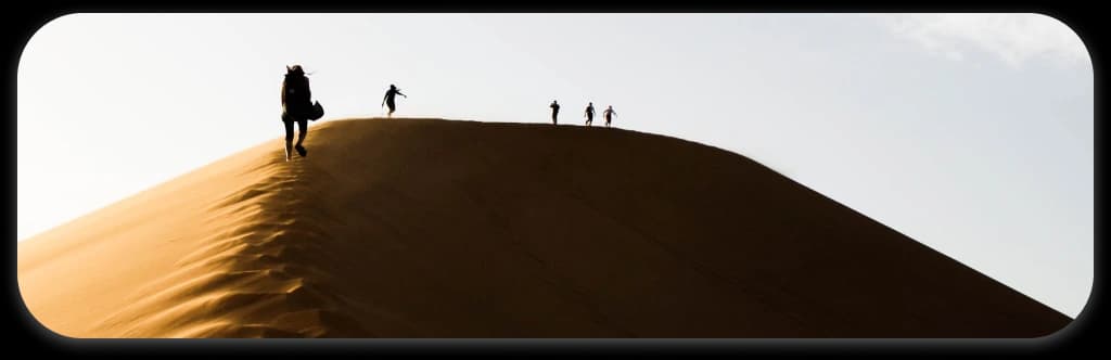 Travelers on desert dune