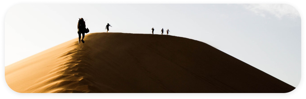 Travelers on desert dune